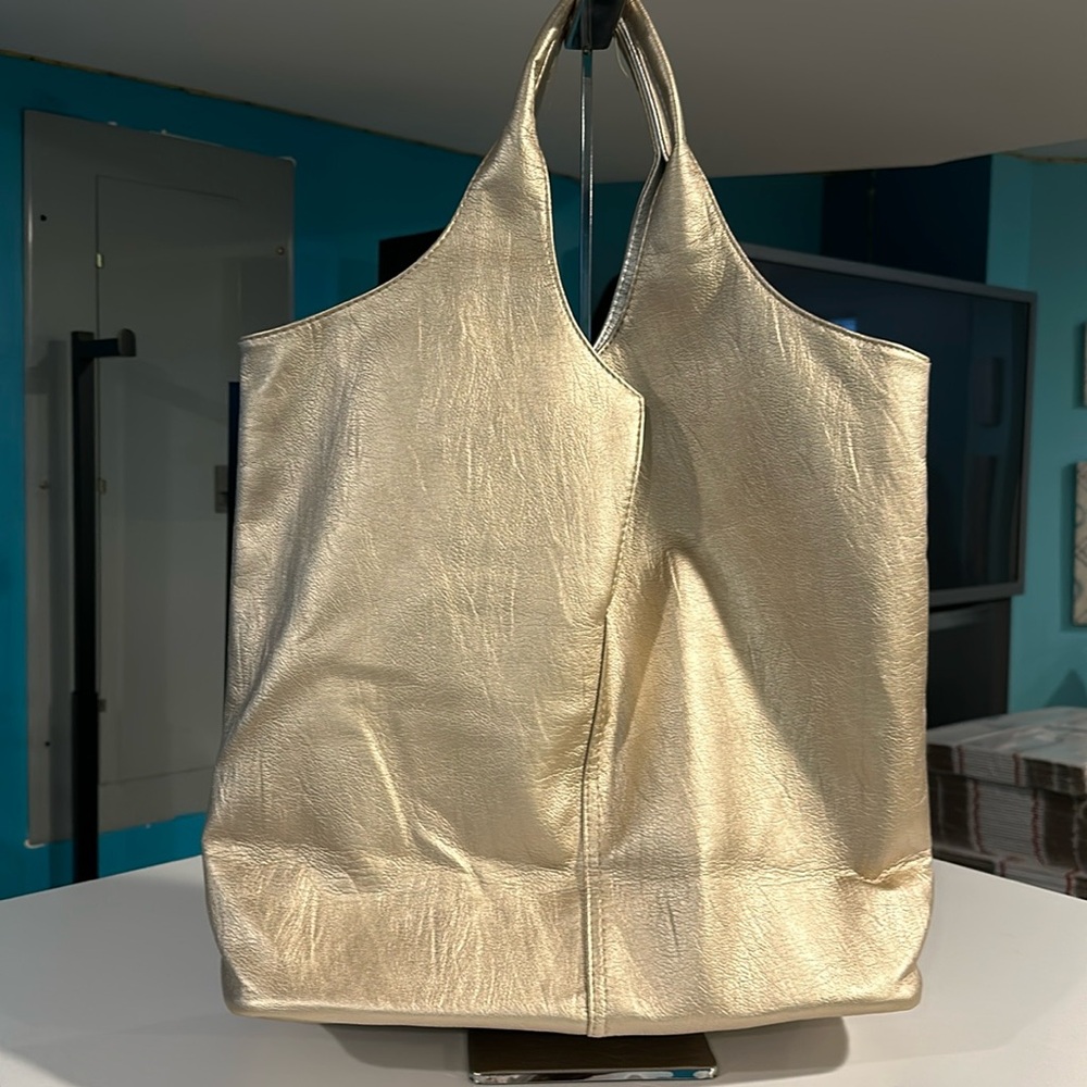 Reversible handbag with gold on one side and silver on the other